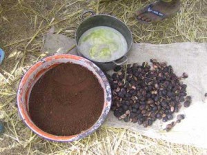 Three stages of shea production: Almonds waiting to be cracked (note the grass mixed in), the "coffee" or ground, dried almonds, and the finished product cooling solid.